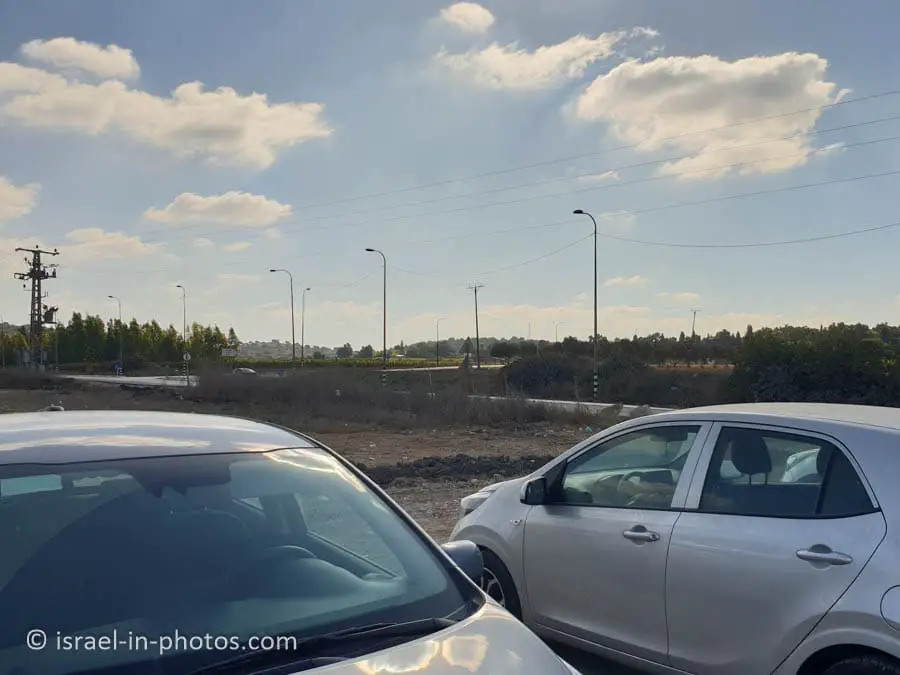 Parking and a sign to Aviel in the background